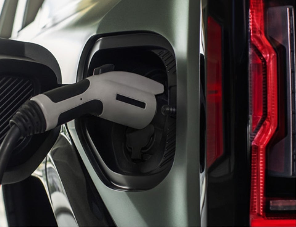 Close up of charging port with charger plugged in on a GMC Hummer EV SUV - Sisbarro GMC in LAS CRUCES NM