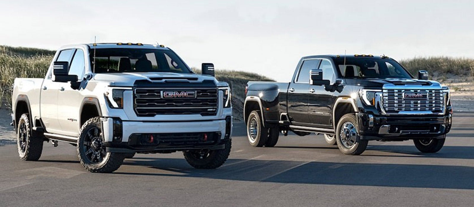 2026 GMC Sierra 2500s parked in front of dunes