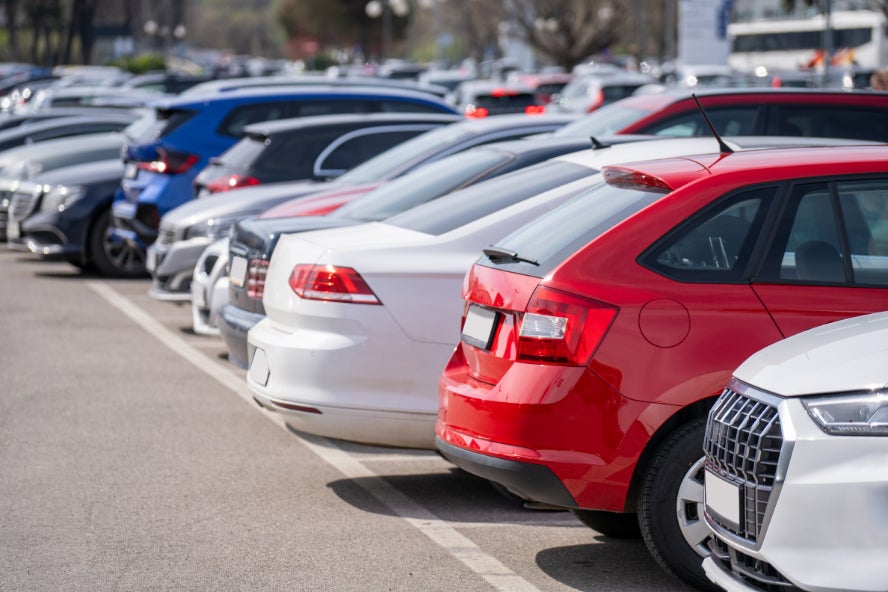A row of cars in a parking lot.