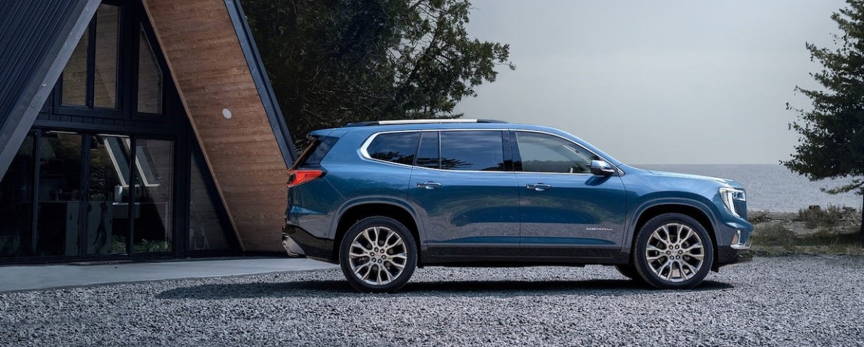 Blue 2026 GMC Acadia parked outside of a house