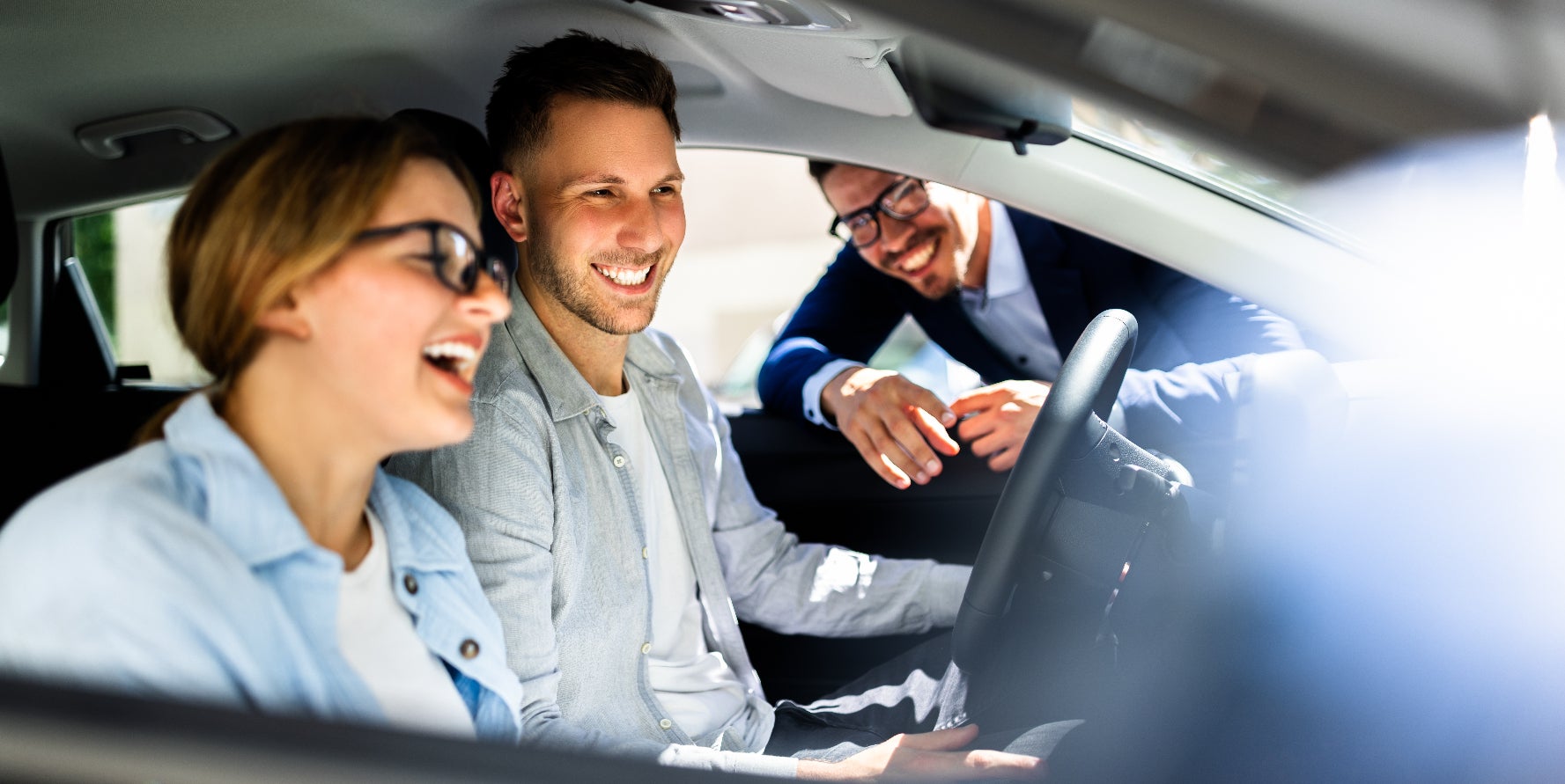 Young couple exploring the features in their new GMC