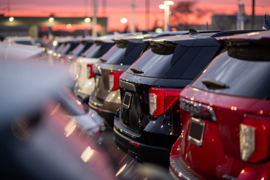 A line of used SUVs in a dealership lot.